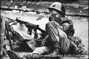 A weary British soldier sits amid the rubble of days of rioting in Belfast.